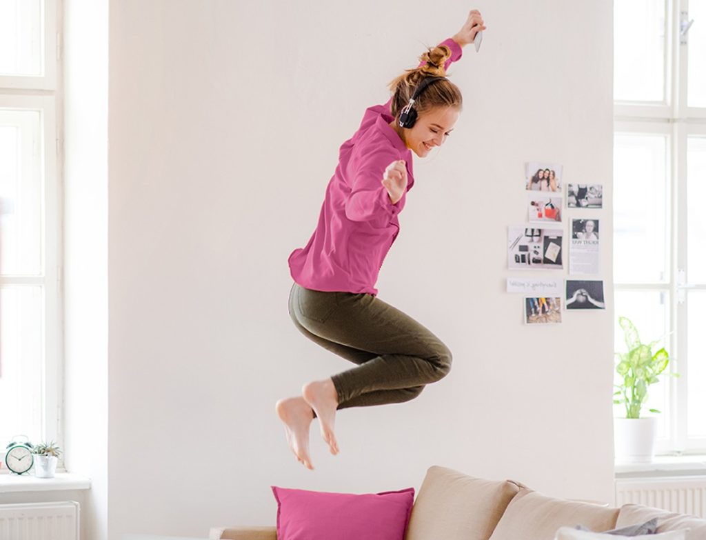 A woman jumping on the bed